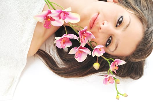 one  beautiful young  woman face with flower and towel