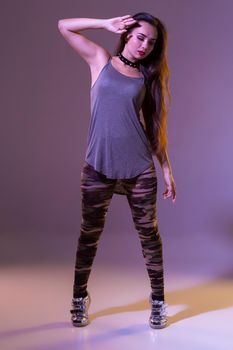 Modern style dancer posing on studio background. Dancing. Hobby. Hip hop, jazz funk, dancehall
