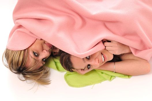 two youg happy giril woman smiling unger blanket isolated representing concept of lesbian love, happynes and softnes