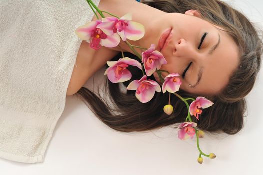 beauty halth and spa wellness isolated young woman face portrait closeup with towel and flower treatment