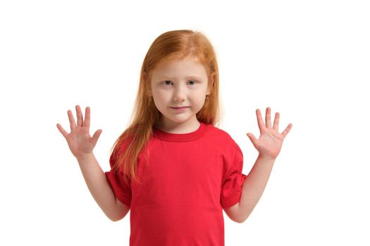 Little girl smiling with his arms up. 5 years old girl surprised with smile and hands near her hands. Red-haired girl in a red T-shirt isolated on white background