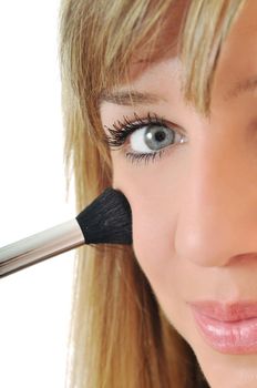 beautiful young woman apply powder makeup with brush isolated on white