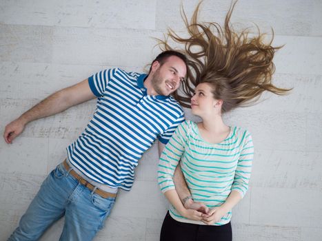 top view of handsome couple lying on floor