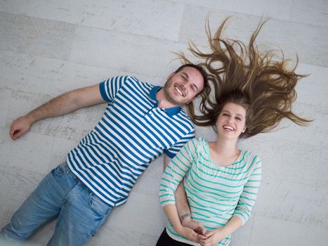 top view of handsome couple lying on floor