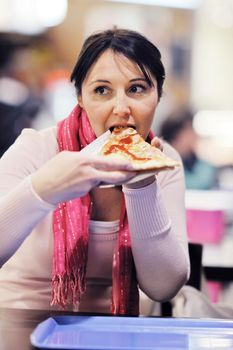 portrait of young woman eat pizza food at restaurant