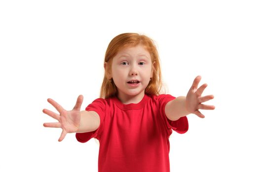 Portrait of cute redhead emotional little girl in red t-shirt isolated on a white. Beautiful studio portrait of female little caucasian person