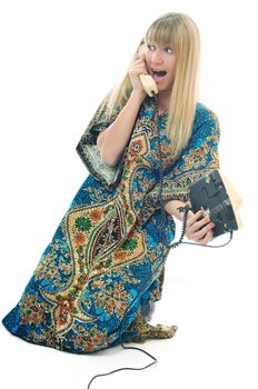 young woman talking by old phone isolated on white