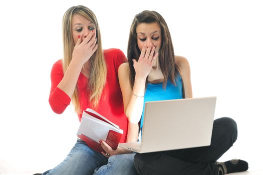 scared and shocked two young woman isolated looking in laptop