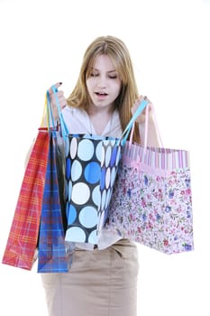 women shopping concept with young lady and colored bags  isolated over white background in studio
