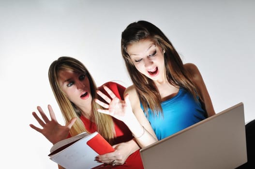 two young woman student work on laptop isolated