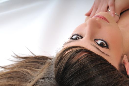 young woman with beautiful face lie on floor isolated closeup