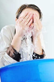 bautiful young woman wash face with clean water isolated on white in studio