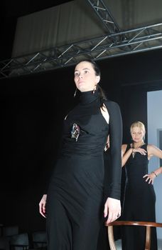 beautiful woman on fashion show piste with gold jawel
