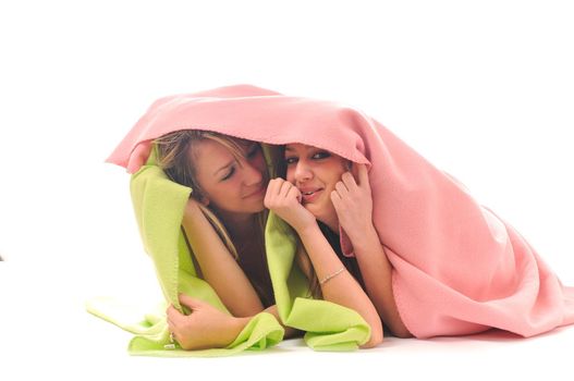two youg happy giril woman smiling unger blanket isolated representing concept of lesbian love, happynes and softnes