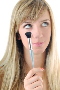 beautiful young woman apply powder makeup with brush isolated on white