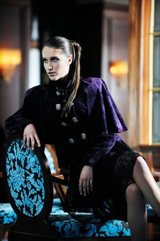 beautiful young woman lay in fashionalbe dress posing in restaurant