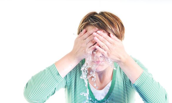 bautiful young woman wash face with clean water isolated on white in studio
