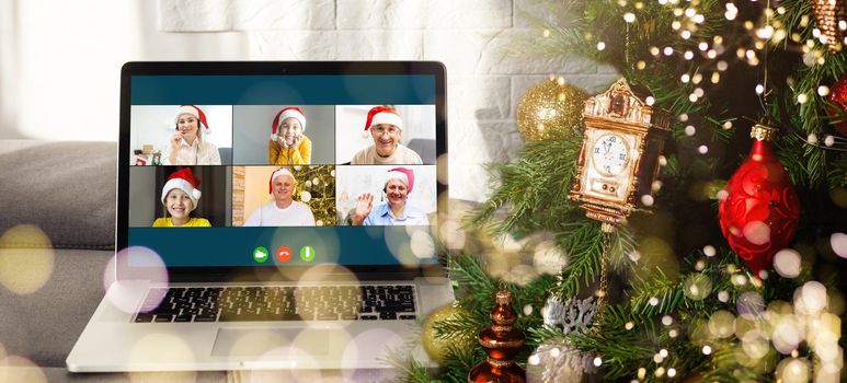 Christmas greetings online. a woman in a white sweater and red Santa hat uses a laptop to make video calls to friends, parents, and for online shopping.