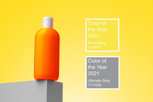 Skincare beauty product container against Illuminating yellow background , colors of year 2021