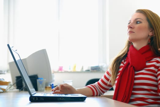 woman in red working on laptop at bright  office