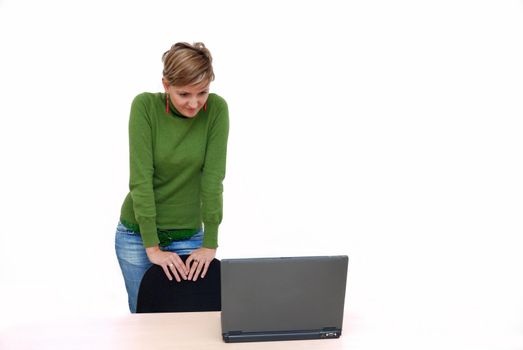 business woman in green standing in office