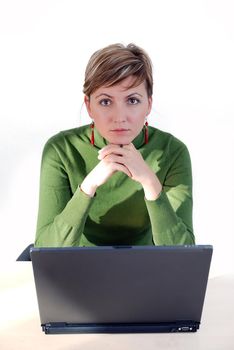 businesswoman in green working on laptop