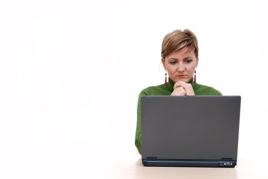 businesswoman in green working on laptop