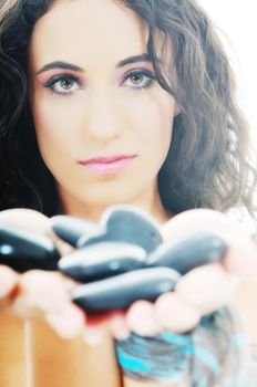 young woman trow in air stones and balancing in hand representing alternative medicine and healthy lifestyle concept