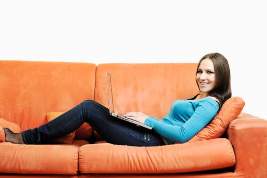 young business woman in casual clothes working on laptop computer on orange sofa isolated on white
