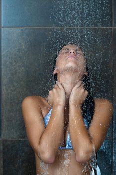 Portrait of a sexy young woman enjoing bath under water shower