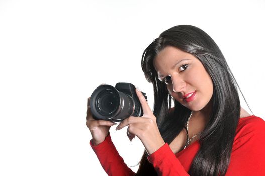 Young woman holding camera in hand taking picture isolated