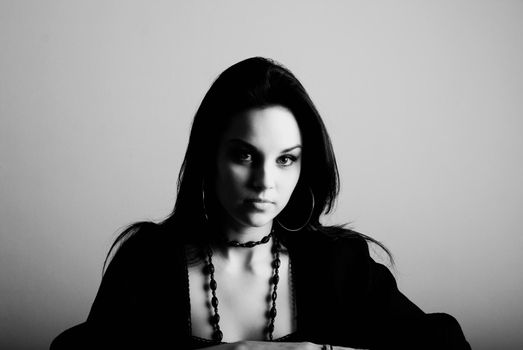 one young beautiful brunette  woman in black posing in studio