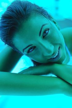 Beautiful young woman have tanning skin treatment in modern solarium