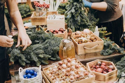 Creation of a Christmas wreath from natural fir and Christmas decorations. Master class on creating a Christmas wreath. made Decor with your own hands. Glass kettle with delicious brewed tea.