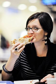 portrait of young woman eat pizza food at restaurant