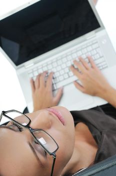 young beautiful business woman isolated on white workling on laptop computer