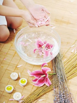 hand spa and beauty treatment with aroma and flowers in water
