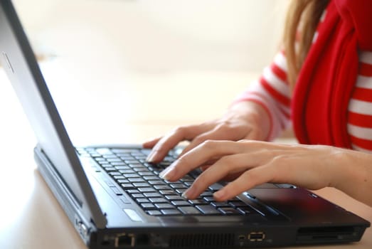 woman in red working on laptop at bright  office