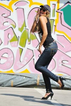 young pretty urban modern fashion woman pose outdoor on street