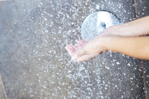 Portrait of a sexy young woman enjoing bath under water shower