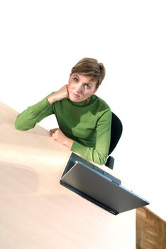 businesswoman in green working on laptop