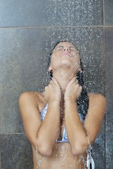 Portrait of a sexy young woman enjoing bath under water shower