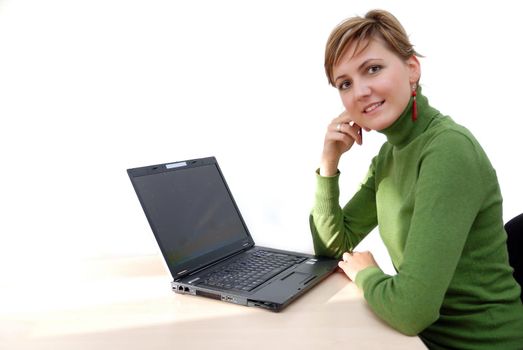 businesswoman in green working on laptop