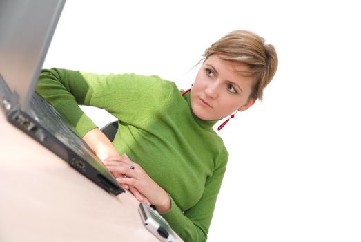 businesswoman in green working on laptop