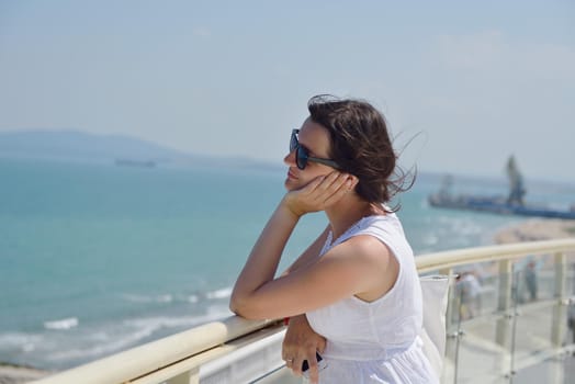 happy young tourist woman have fun while traveling araund city with blue sky and sea in background