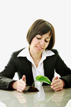 young business woman isolated on white holding green plant with small leaf and waiting to grow