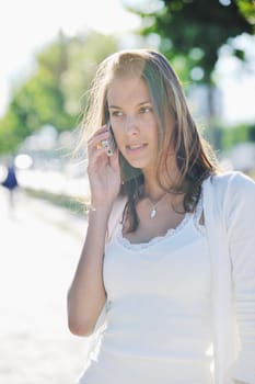 beautiful fit young woman talk by cellphone in city at street on sunny day