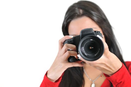 Young woman holding camera in hand taking picture isolated