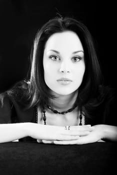 one young beautiful brunette  woman in black posing in studio