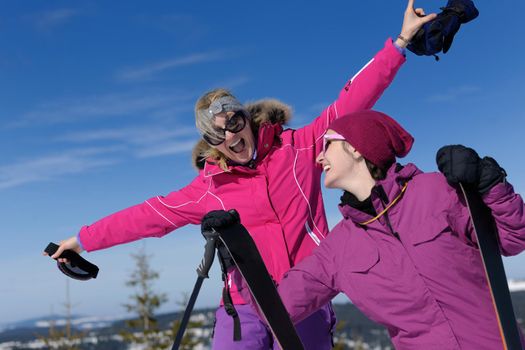 happy friends group of woman girls have fun at winter season at beautiful sunny  snow day with blue sky in background